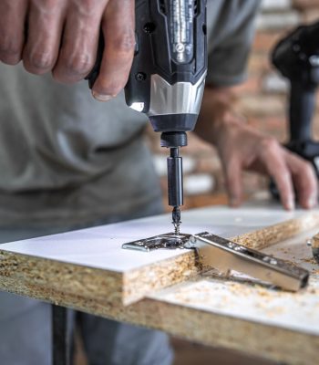 screwing-self-tapping-screw-into-metal-fastening-hole-wood-strip-using-screwdriver-work-carpenter_169016-12966